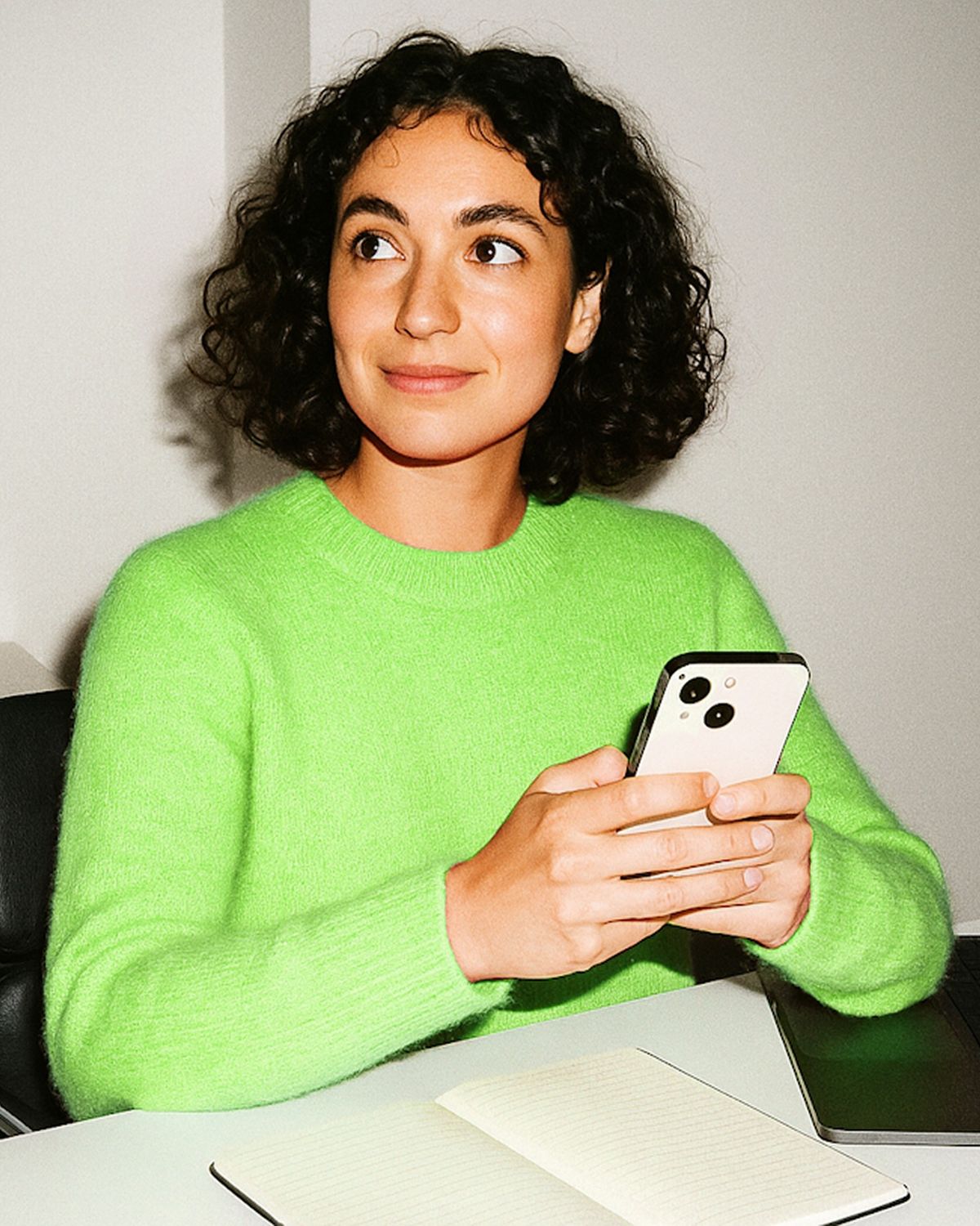 An independent professional checking her phone
